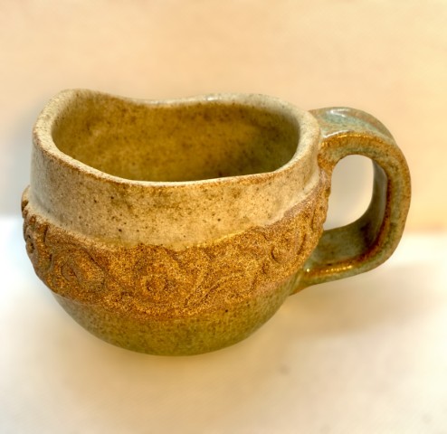 Interor beige. Exterioir con banda esculpida. Inferior y asa verde