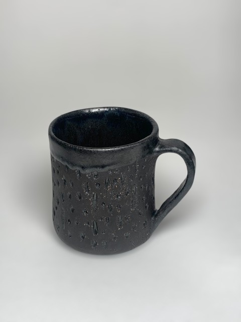 Taza pasta negra interior y bajorelieve azul óceano. Exterior pasta expuesta